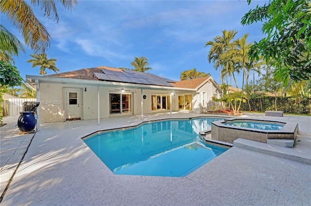 view of swimming pool with a patio area, an in ground hot tub, and ceiling fan