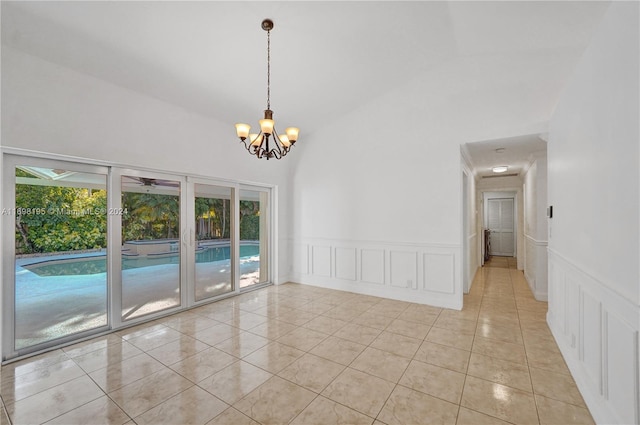 tiled empty room featuring high vaulted ceiling and a notable chandelier