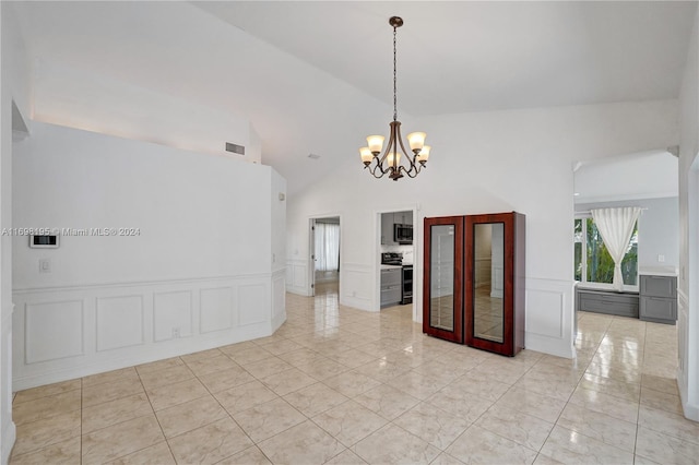 tiled empty room featuring a chandelier, french doors, and high vaulted ceiling