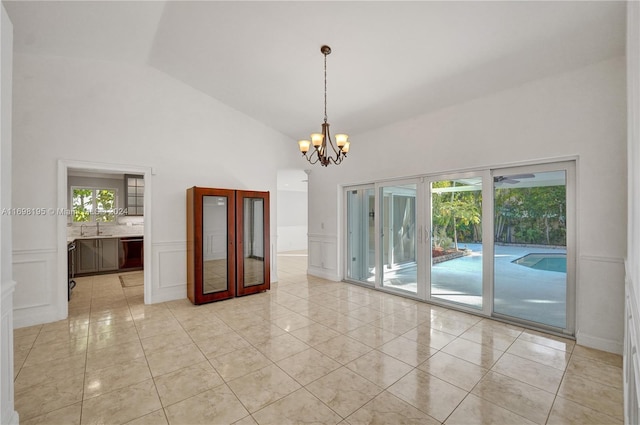 unfurnished room featuring light tile patterned floors, sink, high vaulted ceiling, and a chandelier