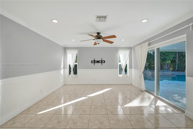 unfurnished room with ceiling fan, crown molding, and light tile patterned flooring