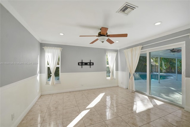 unfurnished room featuring ceiling fan, ornamental molding, and light tile patterned floors