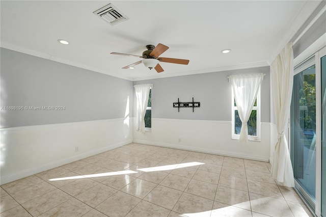 unfurnished room with a wealth of natural light and crown molding