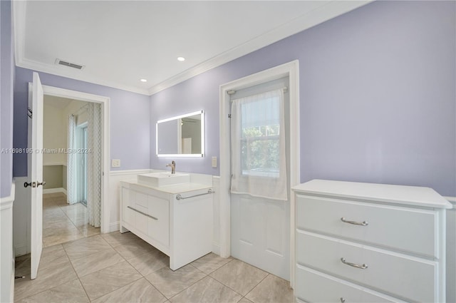 bathroom with crown molding and vanity