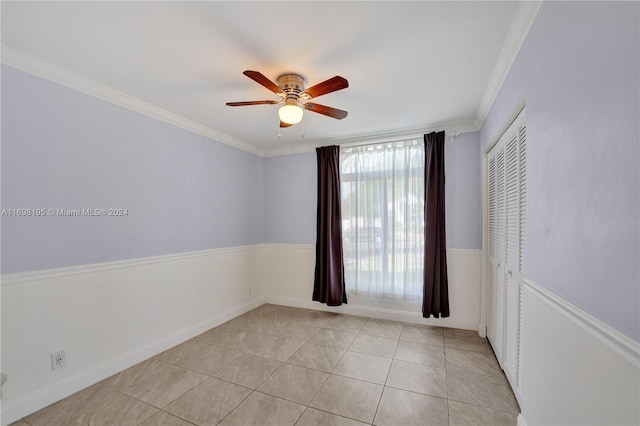 unfurnished bedroom featuring a closet, ceiling fan, ornamental molding, and light tile patterned flooring