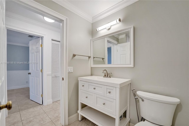 bathroom with vanity, toilet, and ornamental molding