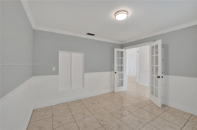 unfurnished room with french doors, light tile patterned floors, and ornamental molding