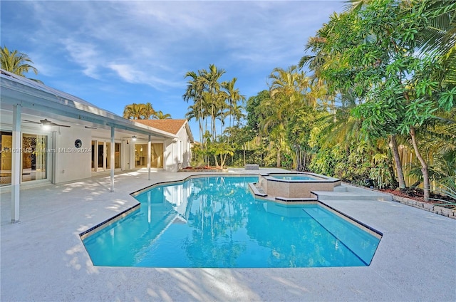 view of swimming pool with ceiling fan, a patio, and an in ground hot tub