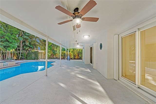 view of swimming pool with an in ground hot tub, ceiling fan, and a patio