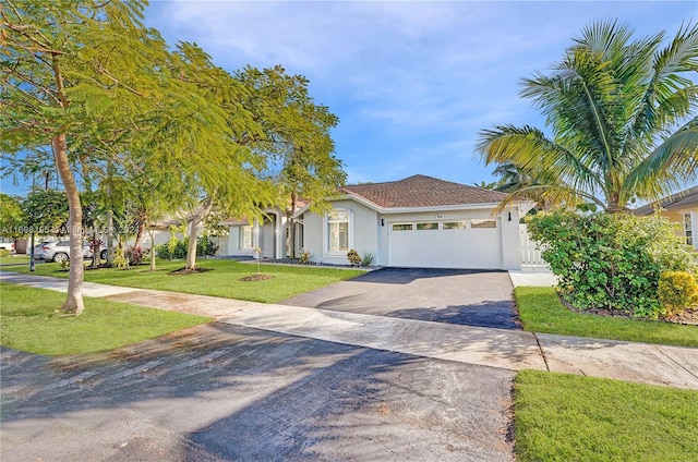 view of front of house featuring a garage and a front yard