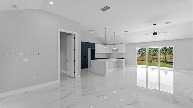 kitchen with pendant lighting, lofted ceiling, a center island with sink, ceiling fan, and white cabinetry