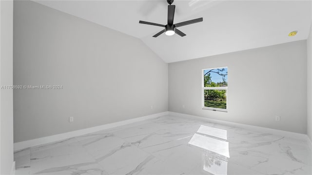 empty room with ceiling fan and vaulted ceiling