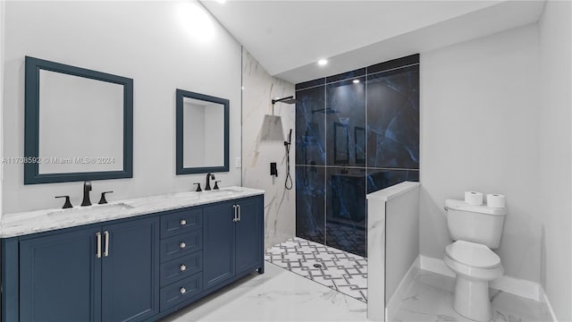 bathroom with a tile shower, vanity, and toilet