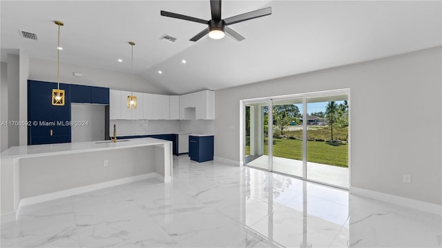 interior space featuring ceiling fan, sink, and vaulted ceiling