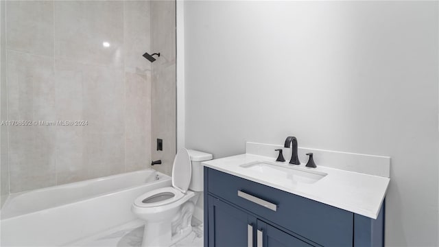 full bathroom featuring vanity, toilet, and tiled shower / bath