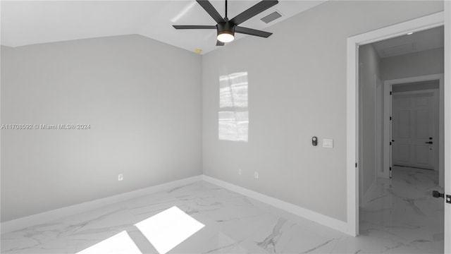 empty room featuring ceiling fan and vaulted ceiling