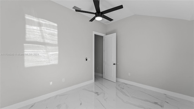 empty room featuring ceiling fan and vaulted ceiling