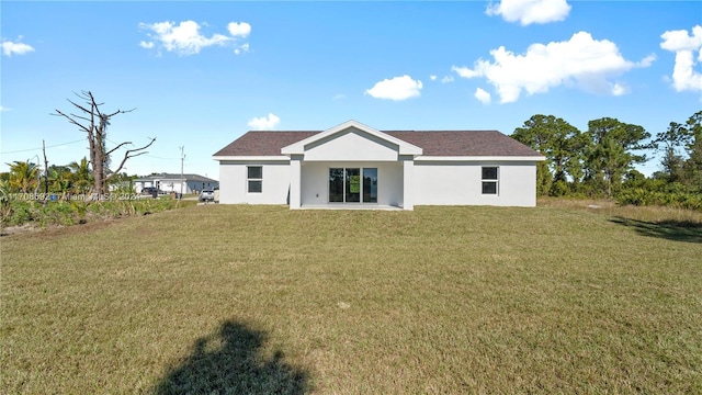 rear view of property with a lawn