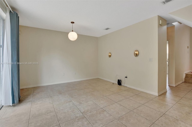 spare room featuring light tile patterned floors