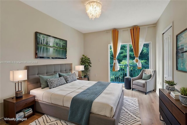 bedroom featuring light hardwood / wood-style flooring and an inviting chandelier