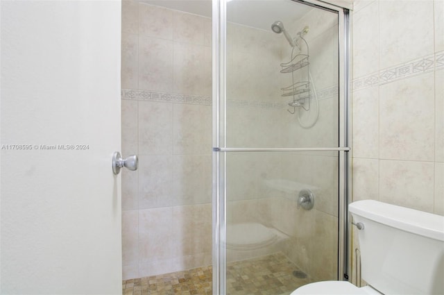 bathroom with toilet and walk in shower