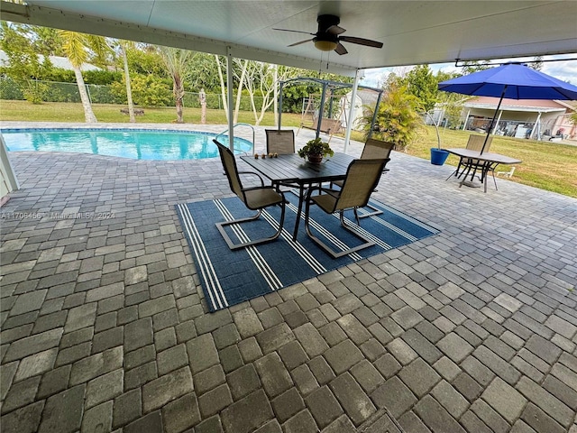 view of pool featuring a yard, a patio, and ceiling fan