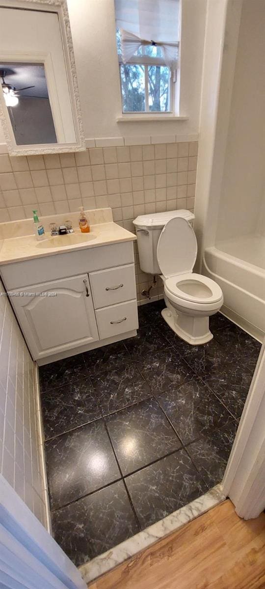 bathroom with vanity, hardwood / wood-style flooring, and toilet