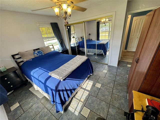 bedroom with ceiling fan and a textured ceiling