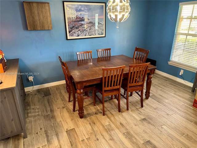 dining area with a chandelier and light hardwood / wood-style floors