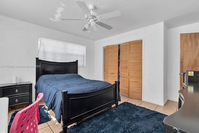 bedroom featuring ceiling fan, a closet, and light tile patterned floors