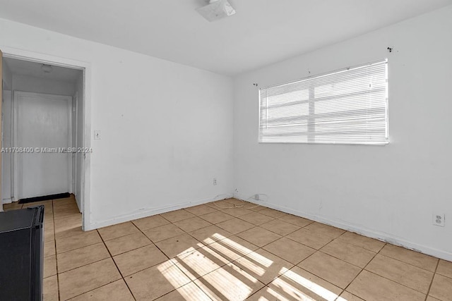 empty room with light tile patterned floors