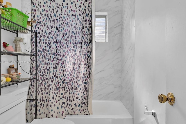 bathroom with shower / bath combination with curtain and toilet