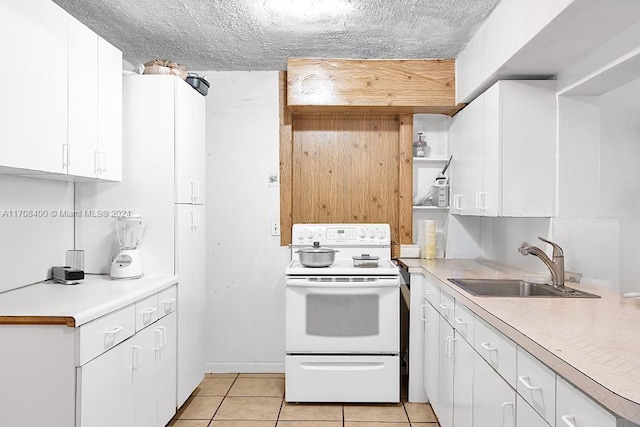 kitchen featuring white range with electric cooktop, white cabinets, sink, light tile patterned floors, and a textured ceiling