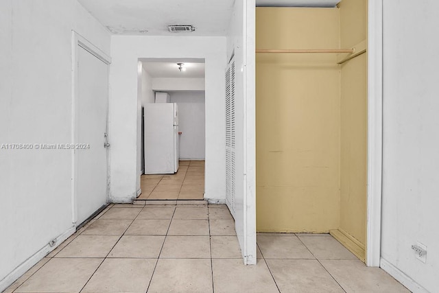 hallway featuring light tile patterned floors