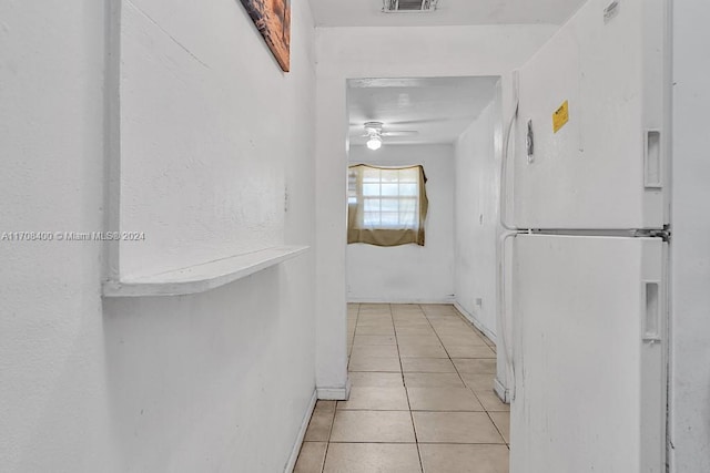 corridor featuring light tile patterned floors