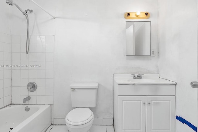 full bathroom featuring vanity, tiled shower / bath combo, and toilet