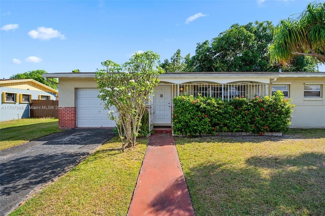 single story home with a garage and a front lawn