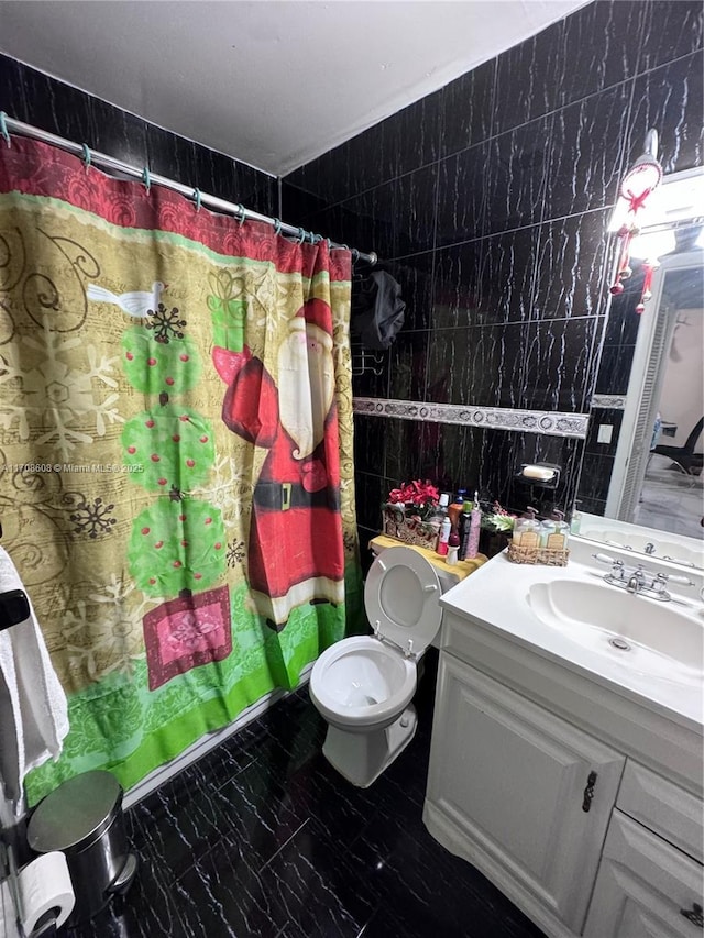 bathroom featuring marble finish floor, tile walls, toilet, vanity, and a shower with curtain