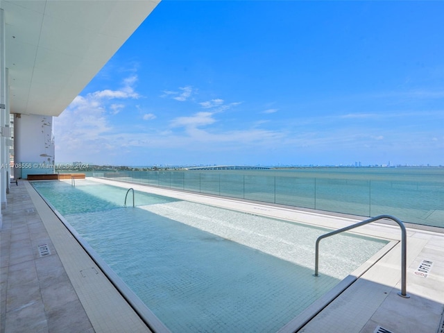 view of swimming pool featuring a water view