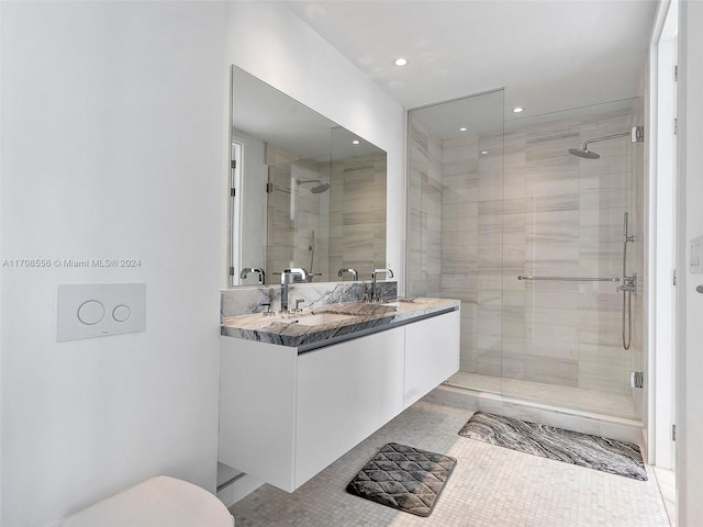 bathroom featuring tile patterned floors, a shower with door, and vanity