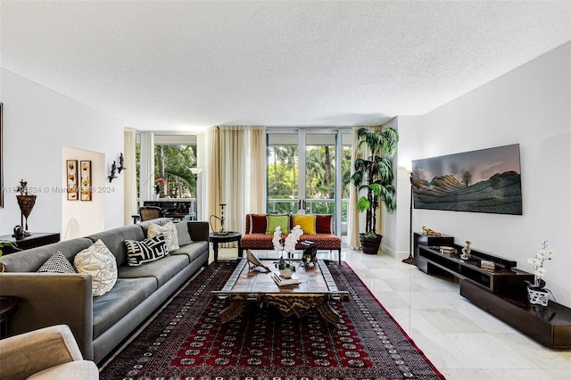 living room with light tile patterned floors and a textured ceiling