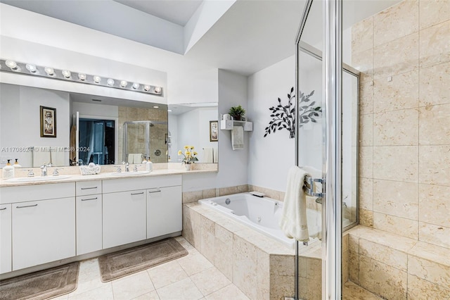 bathroom with tile patterned floors, vanity, and shower with separate bathtub