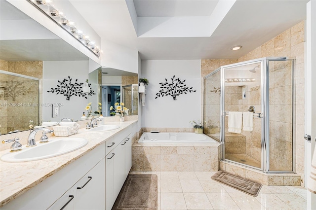 bathroom featuring shower with separate bathtub, vanity, and tile patterned floors