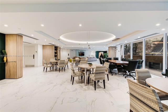 dining room with a raised ceiling