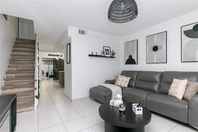 living room featuring light tile patterned floors and a textured ceiling