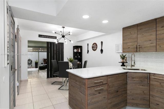 kitchen featuring a chandelier, light tile patterned floors, and sink