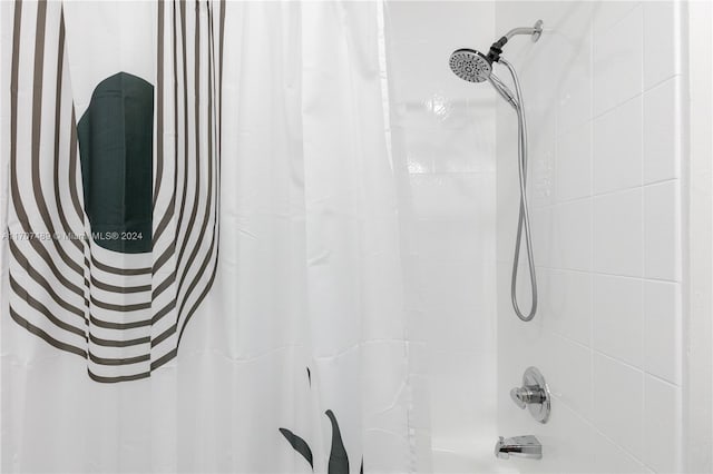 bathroom featuring shower / bathtub combination with curtain