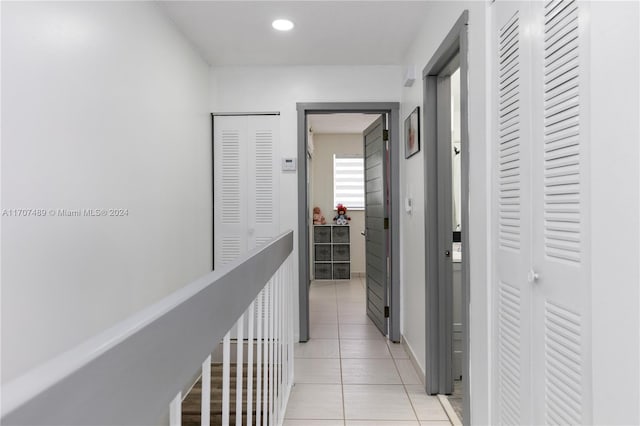 corridor with light tile patterned floors