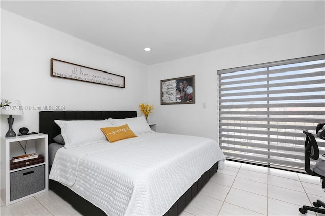 tiled bedroom with multiple windows