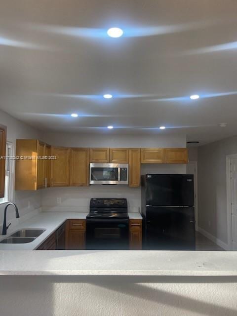 kitchen featuring black appliances and sink